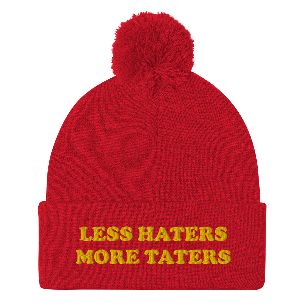 Red Less Haters More Taters Hat from Nina's Funky Shop - Lover potatoes? Looking for a funny gift? This warm and cozy, embroidered beanie is just what you need. It's a classic pom pom beanie with "less haters more taters", expertly embroidered on the front. The perfect funny beanie for potato enthusiasts and foodies of all kinds. Celebrate your favorite foods in our funky foodie apparel.