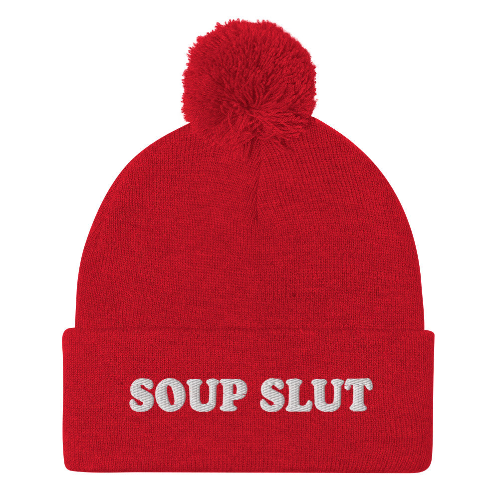 Red Embroidered Beanie with Soup Slut from Nina's Funky Shop - Love soup? Looking for a funny gift for a soup enthusiast? This warm and cozy, embroidered beanie is just what you need. It's a classic pom pom beanie with "soup slut", expertly embroidered on the front. The perfect weird beanie hat for soup sluts and foodies of all kinds. Celebrate your favorite foods in our funky foodie apparel.