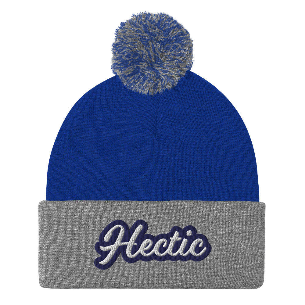 Royal blue and gray Hectic Beanie from Nina's Funky Shop by ninanush - Hectic ⚡ This unique Hectic Hat is warm, cozy, designed by Nina and made just for you. It's a comfortable unisex hectic beanie with a pom pom on top, expertly embroidered with the word "hectic". The perfect funny accessory for everyday streetwear or gift for that hectic friend.