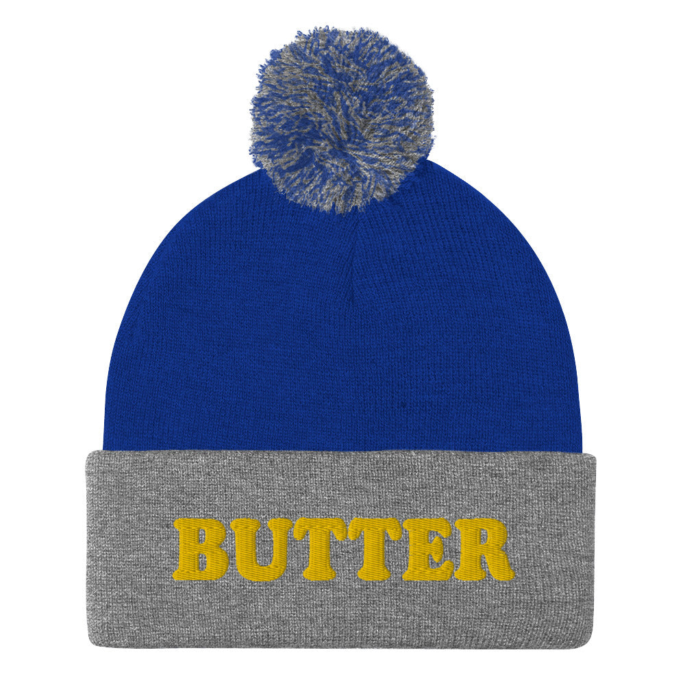 Royal Blue and Gray Butter Beanie - Do you love butter? Looking for a funny gift for a butter enthusiast? This warm and cozy, embroidered beanie is just what you need. It's a classic pom pom beanie with "butter", expertly embroidered on the front. The perfect funny beanie for butter lovers and foodies of all kinds. Celebrate your favorite foods in our funky foodie apparel.