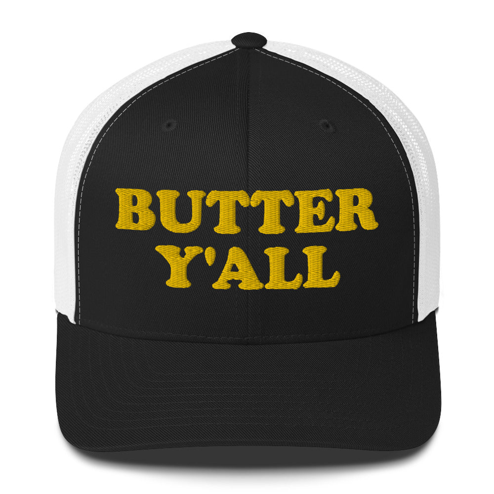 Black and white Butter Hat - Are you a butter enthusiast? Looking for a funny gift? Our Butter Y'all Hat is comfortable and made just for you. It comes in a variety of colors with a funny butter phrase, expertly embroidered on the front. Make a statement and eat your favorite buttery foods in our butter y'all trucker hat.  Edit alt text