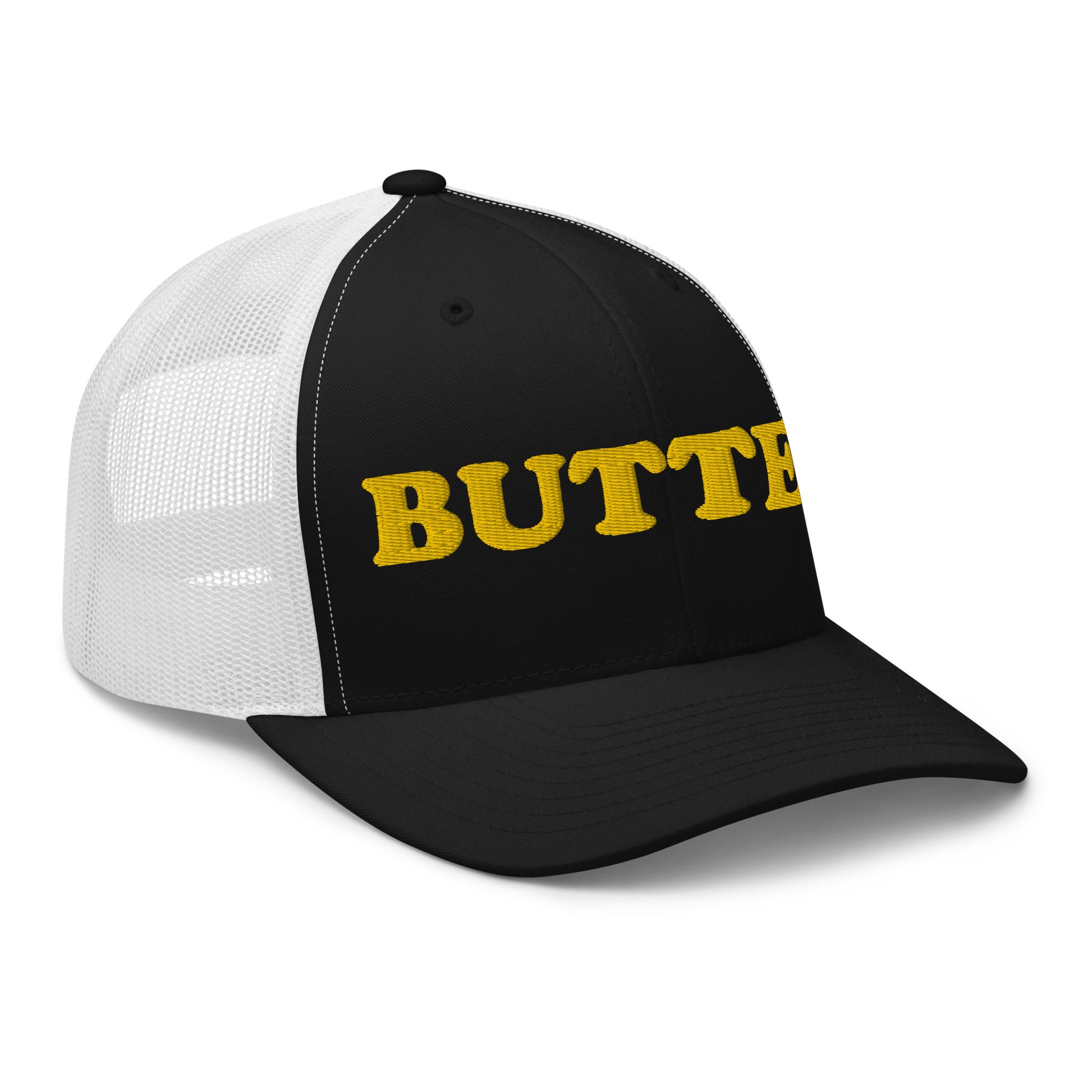 Black and white trucker hat with "butter" on it - Are you a butter enthusiast? Looking for a funny gift? Our Butter Hat is comfortable and made just for you. It comes in a variety of colors with "butter", expertly embroidered on the front. Make a statement and eat your favorite buttery foods in our butter trucker hat.