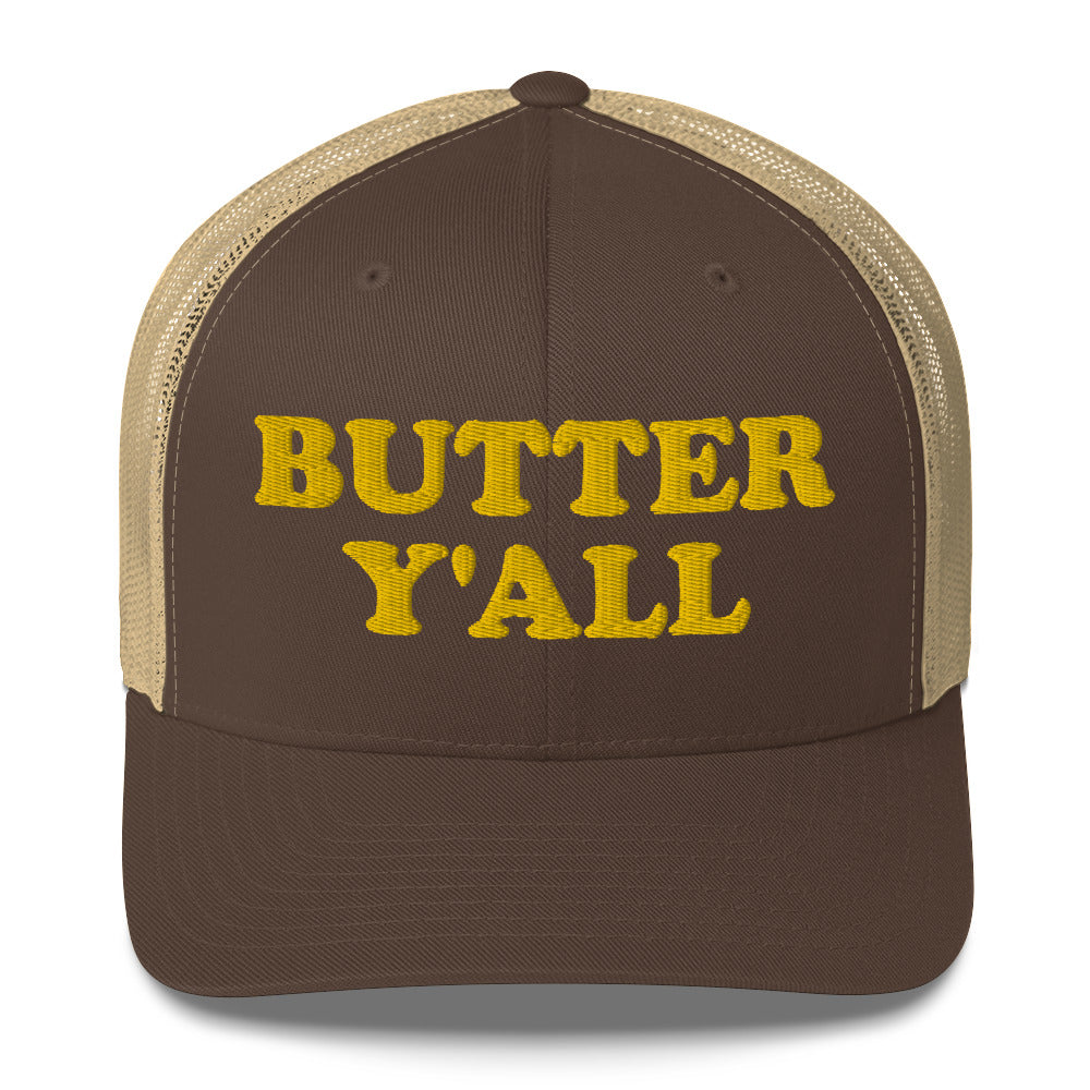 Brown and khaki Butter Hat - Are you a butter enthusiast? Looking for a funny gift? Our Butter Y'all Hat is comfortable and made just for you. It comes in a variety of colors with a funny butter phrase, expertly embroidered on the front. Make a statement and eat your favorite buttery foods in our butter y'all trucker hat.  Edit alt text