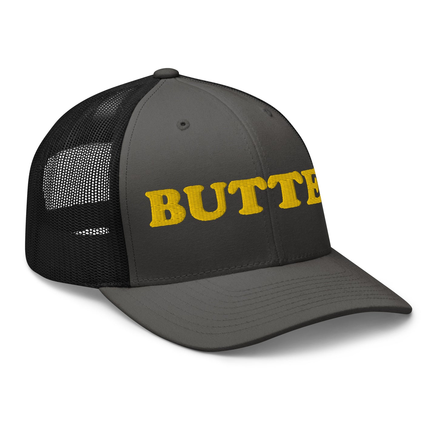 Dark Gray trucker hat with "butter" embroidered on the front in yellow - Are you a butter enthusiast? Looking for a funny gift? Our Butter Hat is comfortable and made just for you. It comes in a variety of colors with "butter", expertly embroidered on the front. Make a statement and eat your favorite buttery foods in our butter trucker hat.