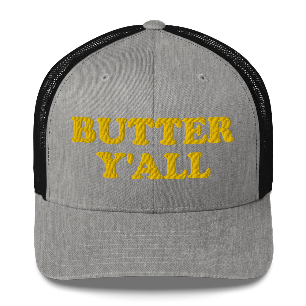 Light Gray and black Butter Hat - Are you a butter enthusiast? Looking for a funny gift? Our Butter Y'all Hat is comfortable and made just for you. It comes in a variety of colors with a funny butter phrase, expertly embroidered on the front. Make a statement and eat your favorite buttery foods in our butter y'all trucker hat.  Edit alt text