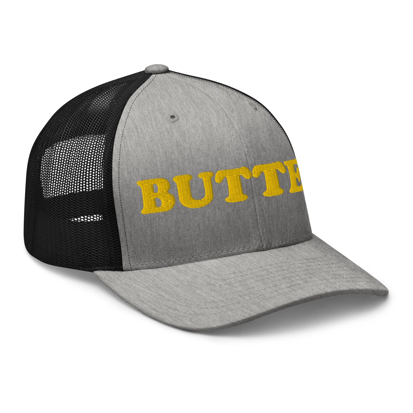 Gray and Black trucker hat with "butter" embroidered on the front in yellow - Are you a butter enthusiast? Looking for a funny gift? Our Butter Hat is comfortable and made just for you. It comes in a variety of colors with "butter", expertly embroidered on the front. Make a statement and eat your favorite buttery foods in our butter trucker hat.