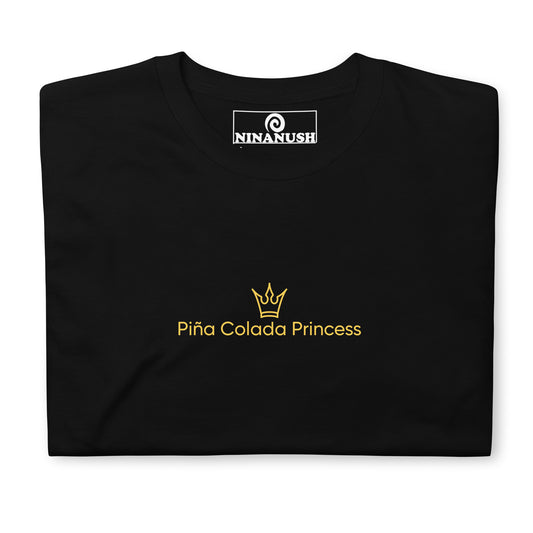 Black pina colada princess shirt - A classic cotton T-Shirt with the words "Piña Colada Princess" printed in yellow with a small crown. It's a soft, comfortable Piña Colada lover shirt that's designed for foodies and made just for you. This funny pina colada t-shirt makes a unique gift for cocktail enthusiasts and unique graphic tee for foodies of all kinds.