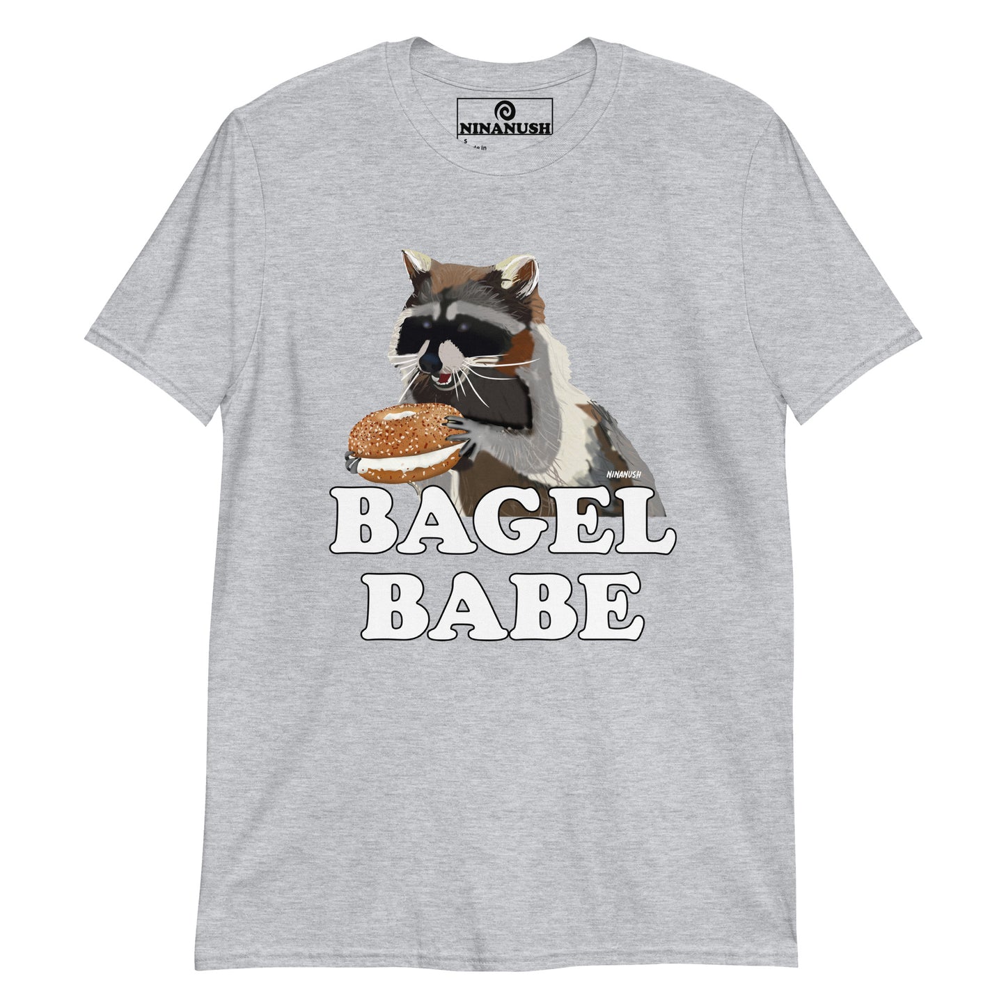 Light Gray Raccoon Bagel Babe T-shirt from Nina's Funky Shop by ninanush - Do you love bagels? Looking for a funny gift for a bagel enthusiast? Our Bagel Babe Raccoon T-shirt is soft, comfortable and just what you need. It's a unisex bagel lover shirt with "bagel babe" and an original hand drawn raccoon eating a bagel. A funny t-shirt for foodies, bagel babes and raccoon lovers alike.