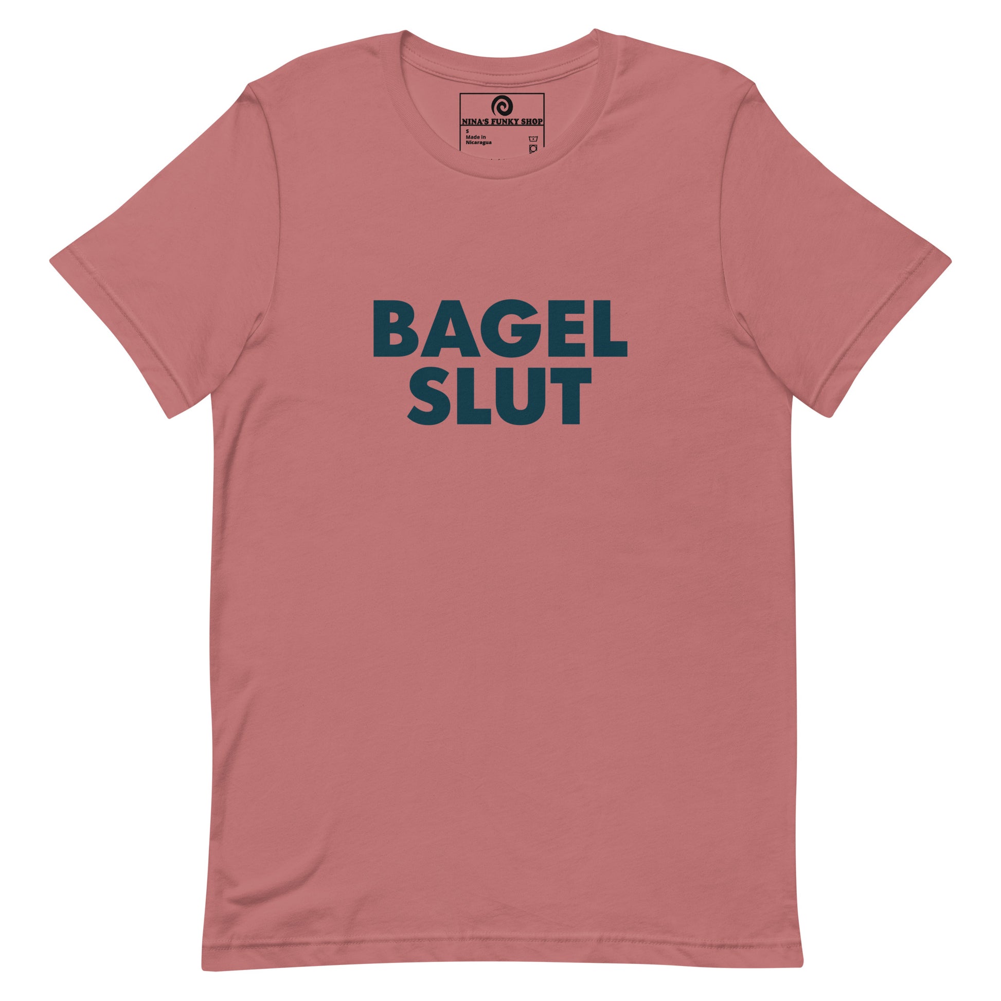 Mauve Bagel Slut T-Shirt - Our Bagel Slut T-shirt is soft, comfortable and just what you need. It's a unisex t-shirt that comes in a variety of colors with a funny foodie design, expertly printed on the front. Stand out in our sarcastic t-shirts and celebrate your favorite foods in our funky foodie apparel. Designed by Nina and made just for you! Looking for something personalized? Shoot us an email!