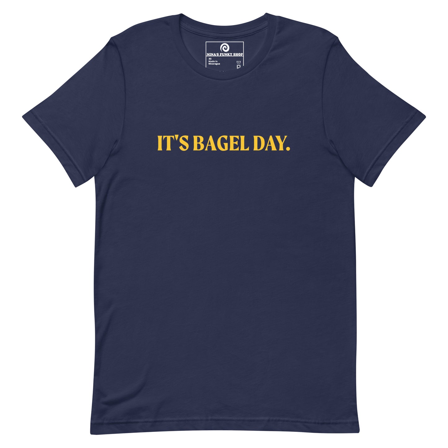 Navy It's Bagel Day T-Shirt - Are you a bagel enthusiast? Looking for a funny gift for a fellow bagel lover? Every day is bagel day in our "It's Bagel Day T-shirt". It's a soft and comfortable, unisex t-shirt that comes in a variety of colors with a funny bagel saying, expertly printed on the front. Eat your favorite bagels and make a statement. Celebrate your favorite foods in our funky foodie apparel.