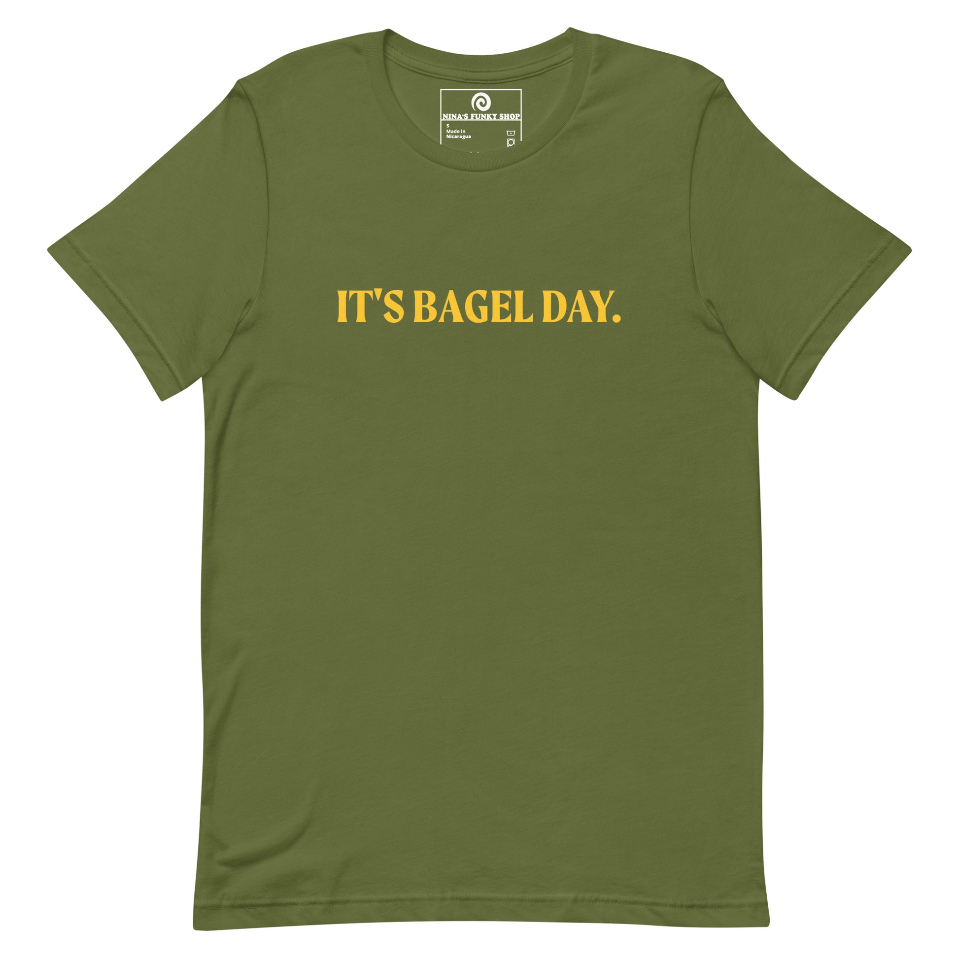 Green It's Bagel Day T-Shirt - Are you a bagel enthusiast? Looking for a funny gift for a fellow bagel lover? Every day is bagel day in our "It's Bagel Day T-shirt". It's a soft and comfortable, unisex t-shirt that comes in a variety of colors with a funny bagel saying, expertly printed on the front. Eat your favorite bagels and make a statement. Celebrate your favorite foods in our funky foodie apparel.