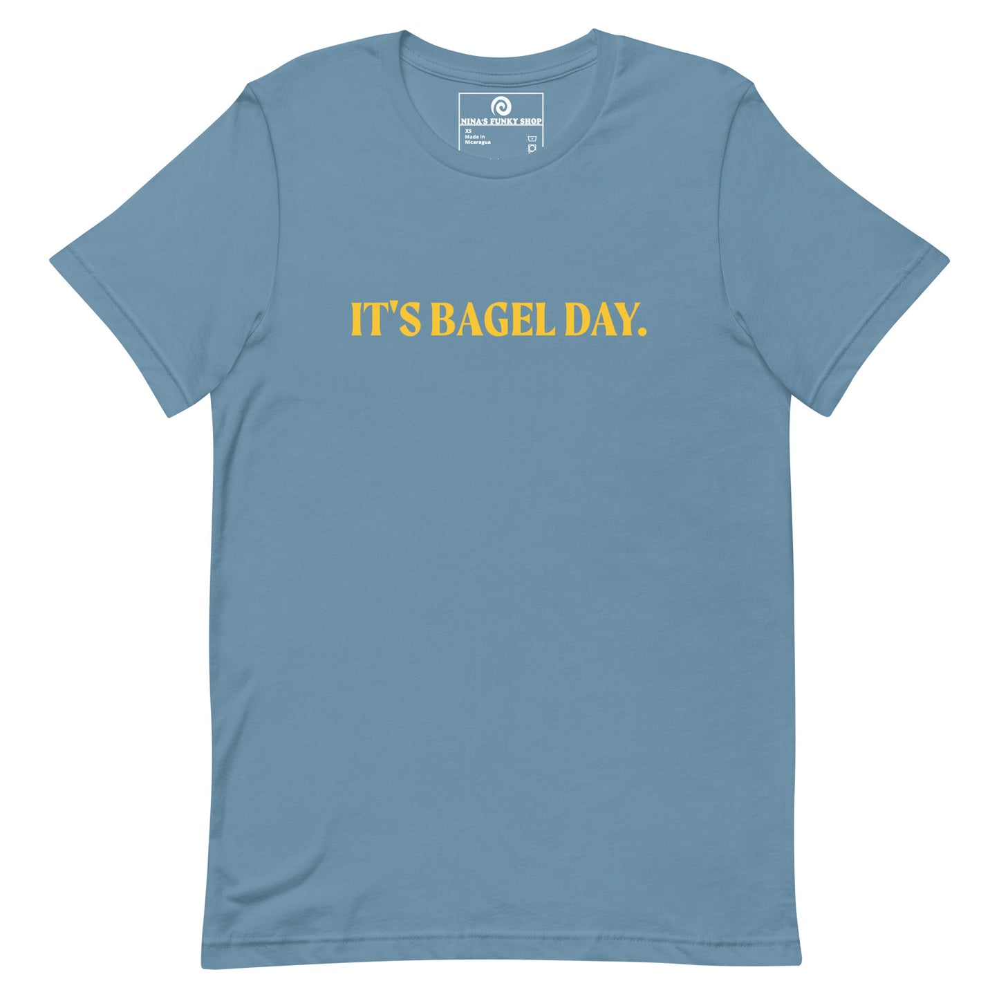 Steel Blue It's Bagel Day T-Shirt - Are you a bagel enthusiast? Looking for a funny gift for a fellow bagel lover? Every day is bagel day in our "It's Bagel Day T-shirt". It's a soft and comfortable, unisex t-shirt that comes in a variety of colors with a funny bagel saying, expertly printed on the front. Eat your favorite bagels and make a statement. Celebrate your favorite foods in our funky foodie apparel.