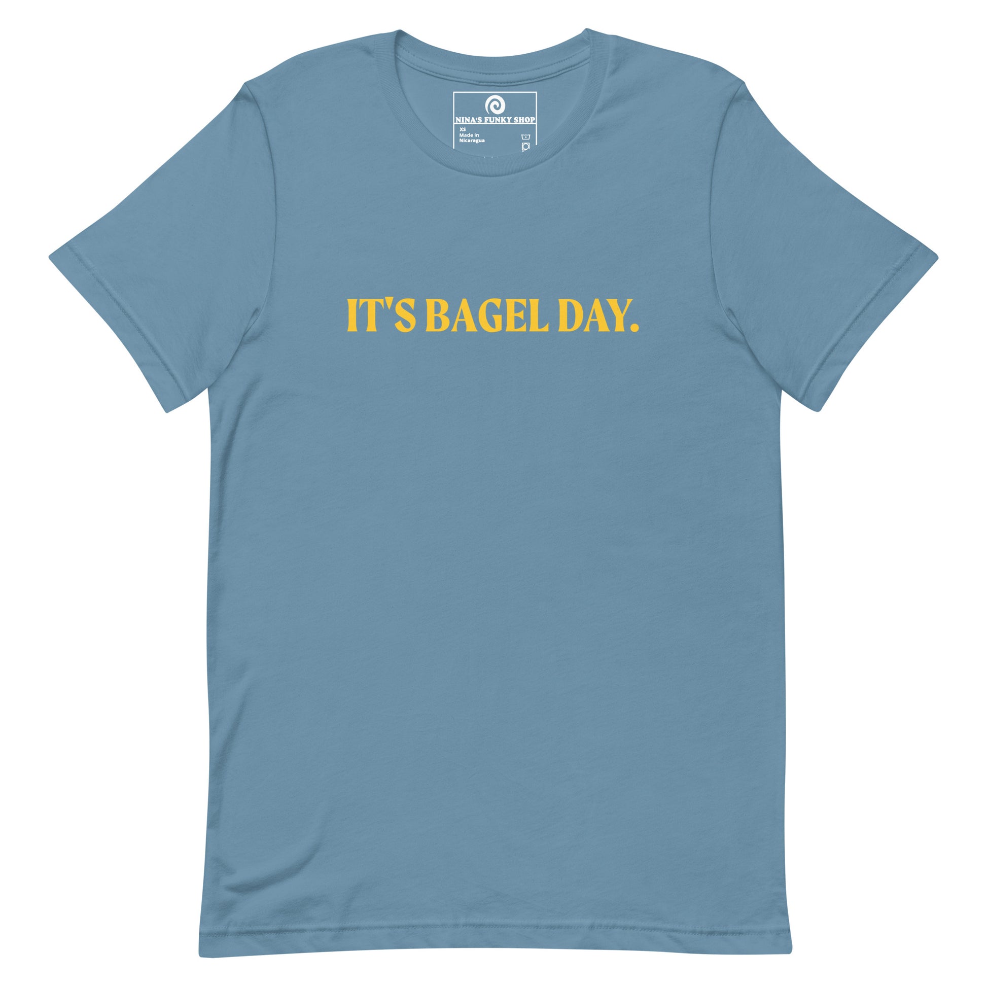 Steel Blue It's Bagel Day T-Shirt - Are you a bagel enthusiast? Looking for a funny gift for a fellow bagel lover? Every day is bagel day in our "It's Bagel Day T-shirt". It's a soft and comfortable, unisex t-shirt that comes in a variety of colors with a funny bagel saying, expertly printed on the front. Eat your favorite bagels and make a statement. Celebrate your favorite foods in our funky foodie apparel.