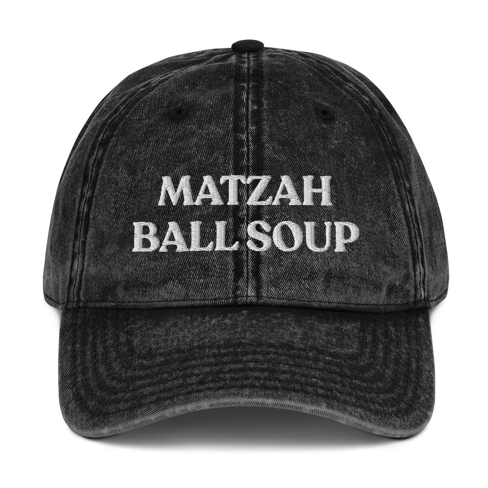 Black Matzo Ball Soup Hat - Love matzah ball soup? Looking for a funny gift for the holidays? This Matzah Ball Soup Hat is comfortable, has an adjustable closure, and comes in a variety of colors with the funny food design, expertly embroidered on the front. The perfect hat for matzah ball lovers and foodies of all kinds. Celebrate your favorite foods in our funky foodie clothing and accessories. 