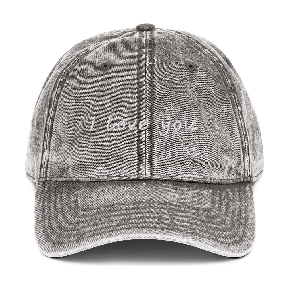 Gray I Love You Hat - Let your hat do the talking and spread the love in our "I Love You Dad Hat." It's a classic cotton dad hat with a positive design, expertly embroidered on the front. Looking for something personalized? Shoot us an email!