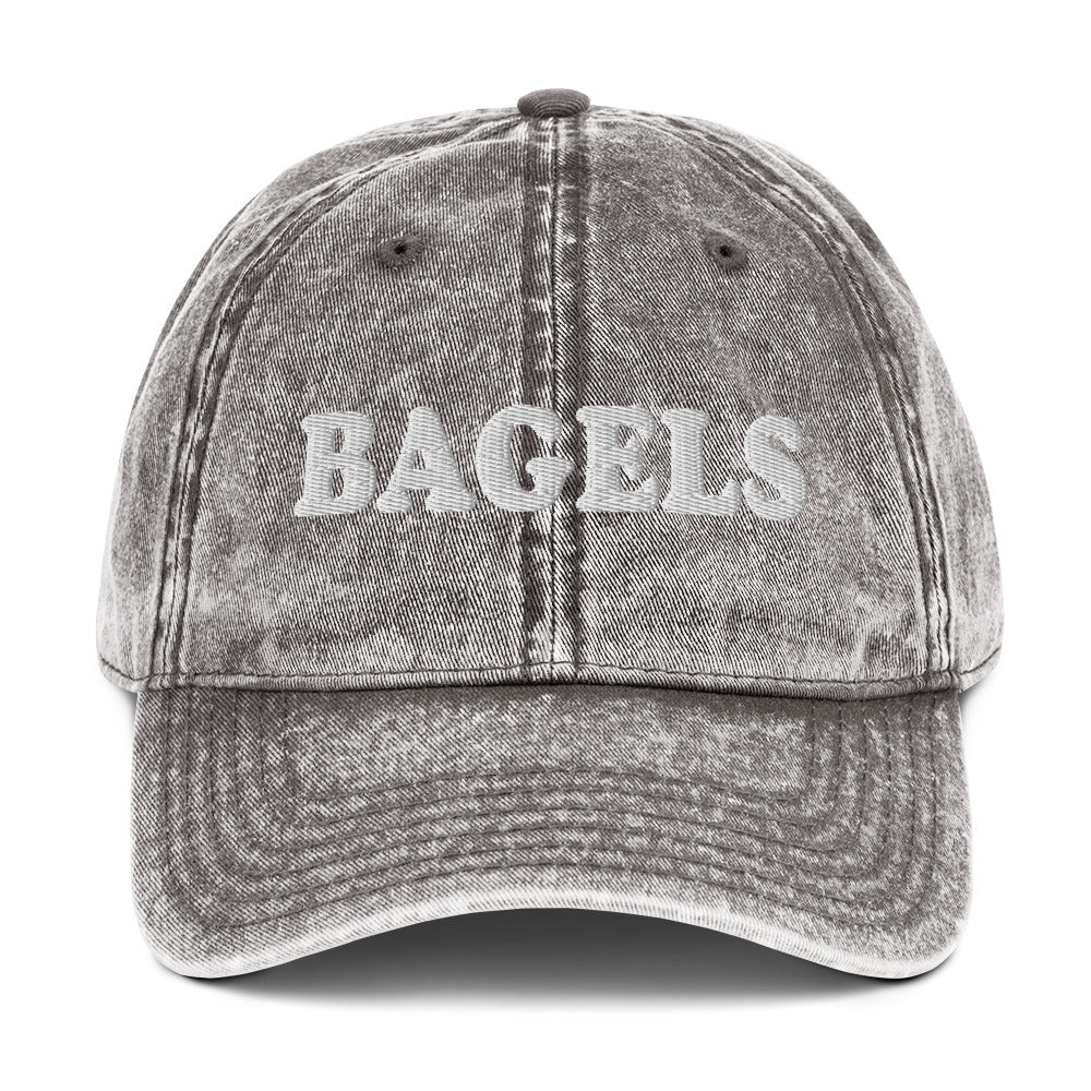 Gray Bagels Hat - Our vintage style Bagels Hat is comfortable, adjustable and made just for you. It comes in a variety of colors with a Bagels, expertly embroidered on the front. The perfect hat for bagel enthusiasts and everyday foodies of all kinds.