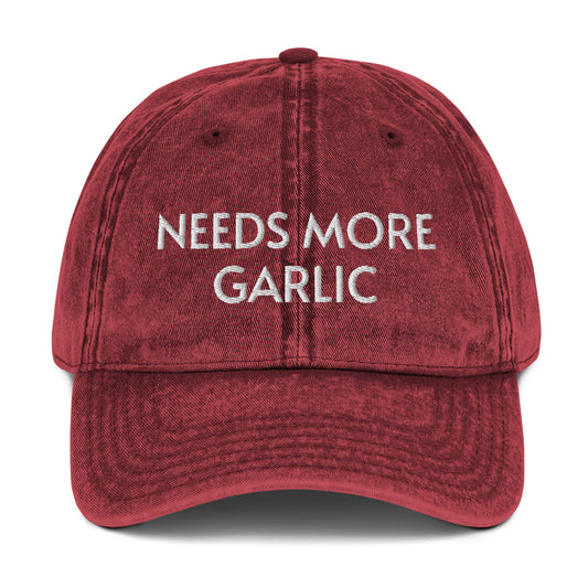 Maroon needs more garlic dad hat from Nina's Funky Shop by ninanush - If you're a garlic enthusiast, this funny food hat was designed just for you. Eat garlicky snacks in style and show off your love for garlic in our unique foodie dad hat. This garlic lover hat is made of cotton, with a washed out vintage style and an eye-catching embroidery. Perfect for garlic lovers and foodies.