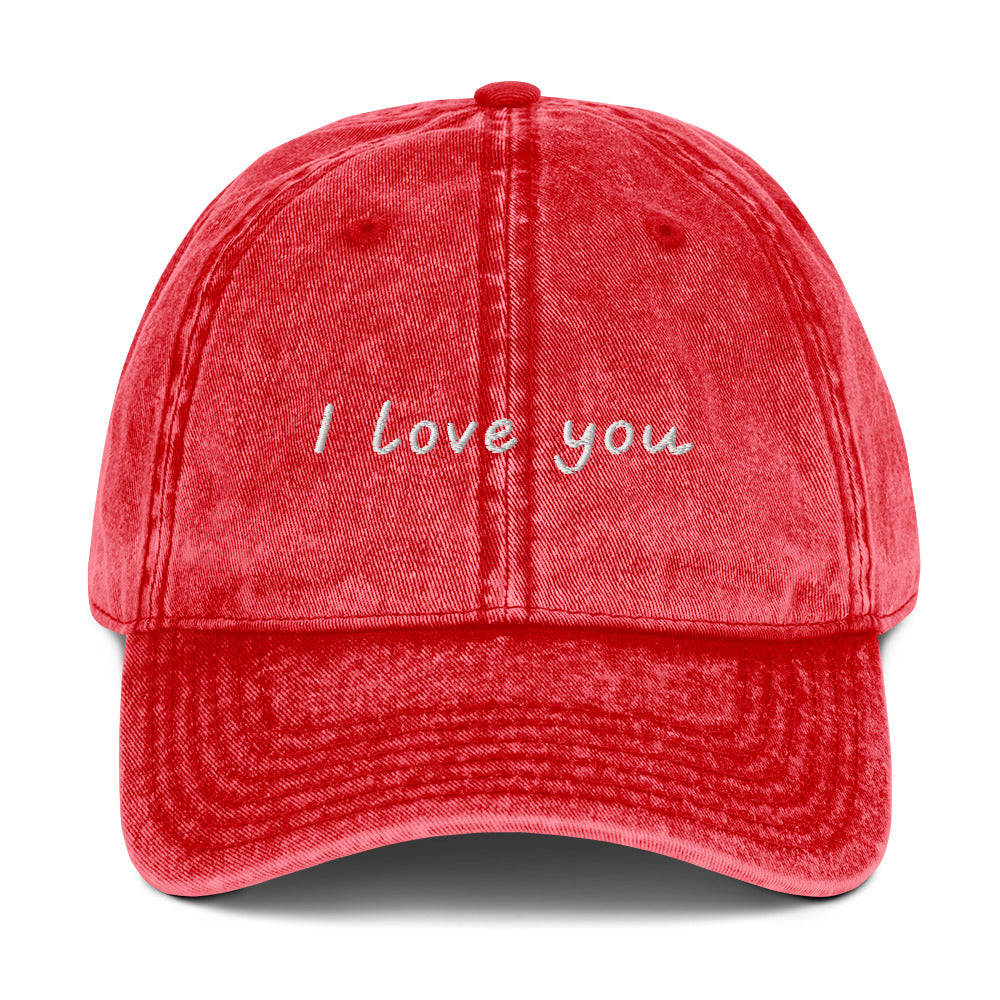 Red I Love You Hat - Let your hat do the talking and spread the love in our "I Love You Dad Hat." It's a classic cotton dad hat with a positive design, expertly embroidered on the front. Looking for something personalized? Shoot us an email!