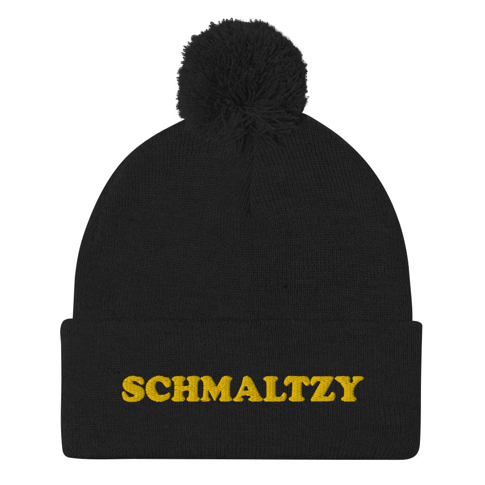 Cute, warm and cozy, schmaltzy beanie. Black or navy with yellow schmaltzy embroidery and a pom pom on top. This classic beanie and unusual schmaltzy design is a funky hat that's stylish, warm and comfortable. Shop weird hats, foodie beanies, funky crop tops, shirts for garlic lovers and more. All original designs by us.