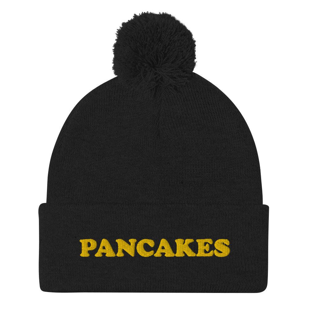 Everyone loves pancakes and now you can show your love in this funny foodie pancake beanie. This unique embroidered "PANCAKES" beanie is warm and cozy with a classic pom pom. It's a perfect gift for foodies and weird hat people. Shop vegan foodie beanies, garlic hoodies, and funky designs in our shop. 