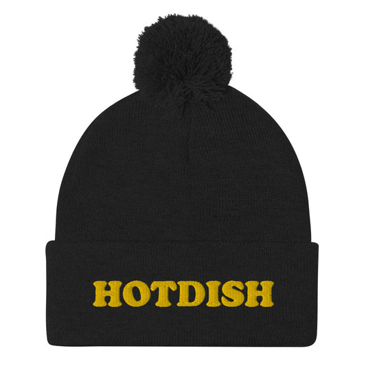 'HOTDISH' Pom-Pom Beanie. This funky foodie beanie is a warm and cozy hat for cold weather. It's a classic beanie with a pom pom and a unique hotdish embroidery. This funny beanie is unique and weird and a perfect funny hat for a unique gift idea. Ideal for foodies who love hotdish and funky foodie beanies. 