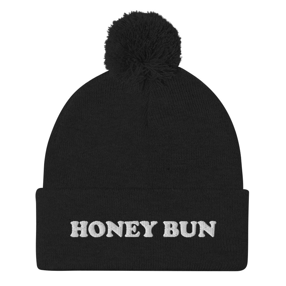 Black honey bun beanie for foodies - Honey Bun Pom-Pom Beanie. This cute foodie beanie is a perfect warm and cozy hat for cold weather. It's a classic beanie with a pom pom on top and unique white embroidery. The funny honey bun hat is a weird foodie hat that's a perfect gift for foodies and honey bun lovers.  Stay warm in our funky foodie clothing.