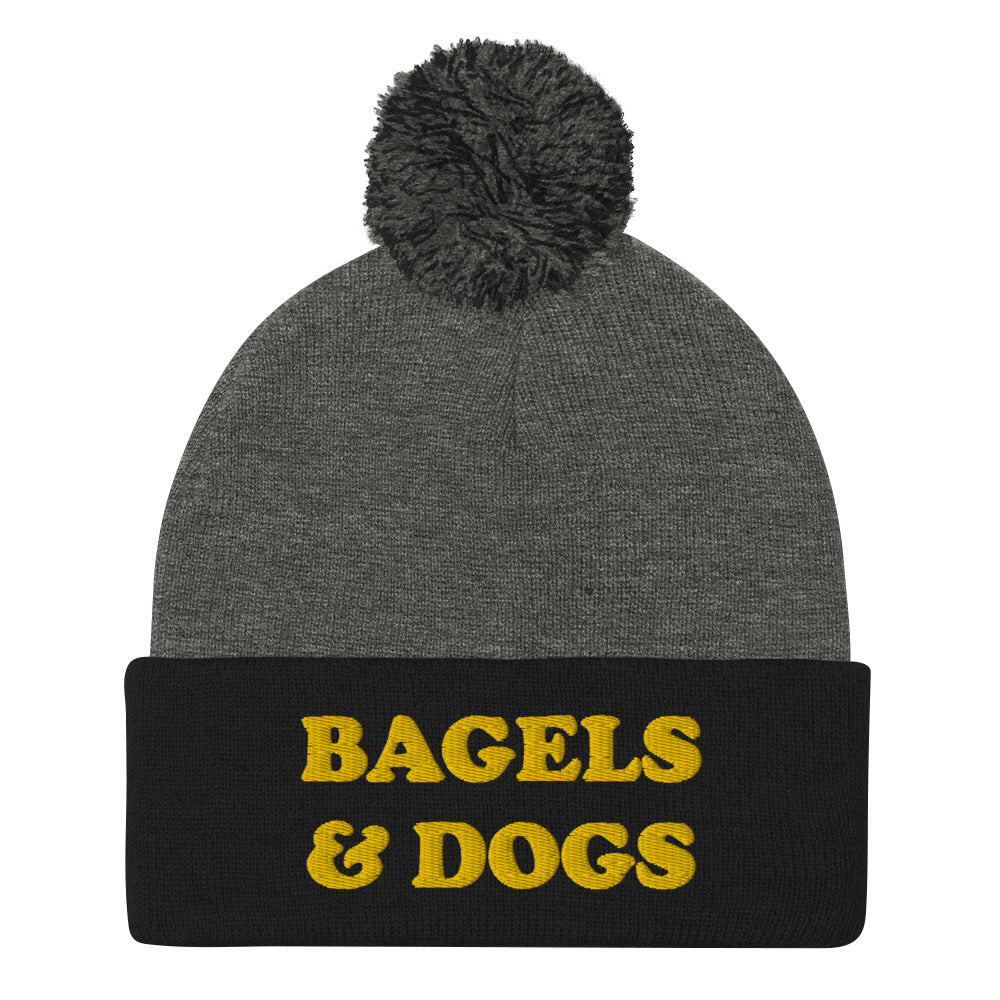 Bagels and dogs beanie in black and gray - Keep your priorities in check with this bagels and dogs beanie with a pom pom on top. It's a unique and funny beanie for foodies and animal lover. Now you can eat bagels and pet dogs in a cozy hat that makes people smile. Stay weird and celebrate your favorite foods and animals in our funky clothing and accessories.