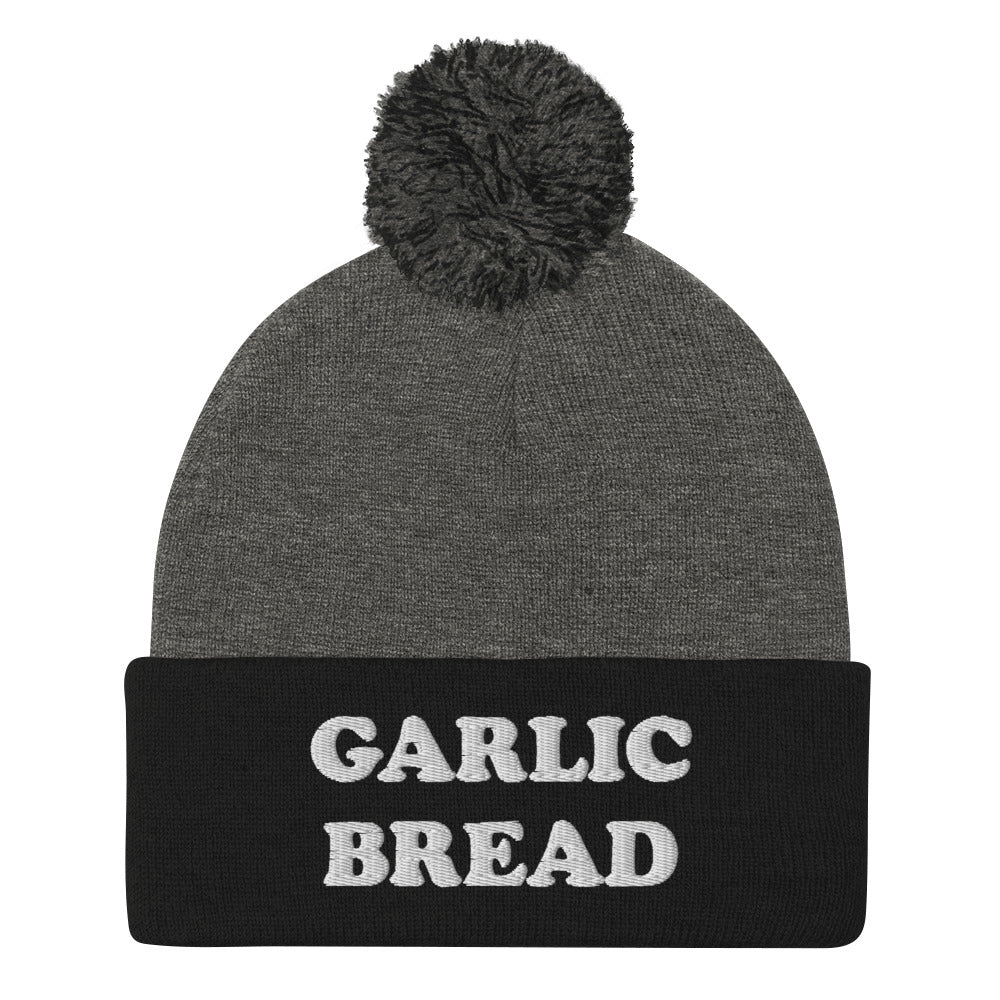 Gray and Black with white embroidery garlic bread beanie - This garlic bread beanie is a perfect warm and cozy hat for cold weather. Everyone loves garlic bread and now you can eat it in a classic beanie with a pom pom on top. Stay funky in this weird hat for foodies and garlic bread enthusiasts. It's funny, unusual and sure to get attention from your garlic loving friends.