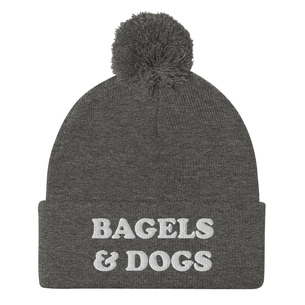 Gray bagels and dogs beanie with white embroidery - Keep your priorities in check with this bagels and dogs beanie with a pom pom on top. It's a unique and funny beanie for foodies and animal lover. Now you can eat bagels and pet dogs in a cozy hat that makes people smile. Stay weird and celebrate your favorite foods and animals in our funky clothing and accessories.