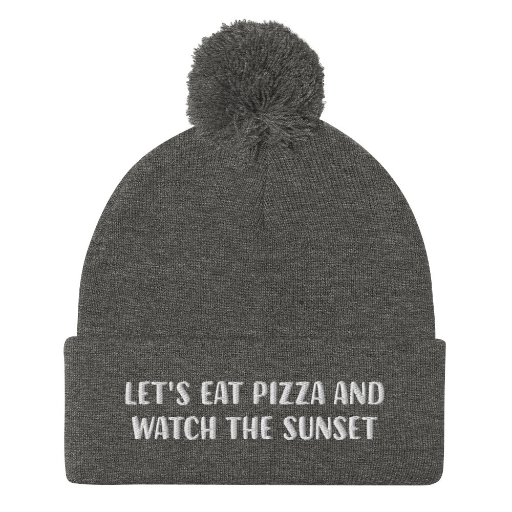 Funny foodie beanie in gray for pizza and sunset lovers - Let's eat pizza and watch the sunset in a unique beanie with a funny message. This cute beanie is a warm hat for cozy nights in and outdoor adventures. It's a classic unisex embroidered beanie with a pom pom on top. Love sunsets and pizza? Wear this funny foodie beanie or give it as a unique gift for pizza lovers.  