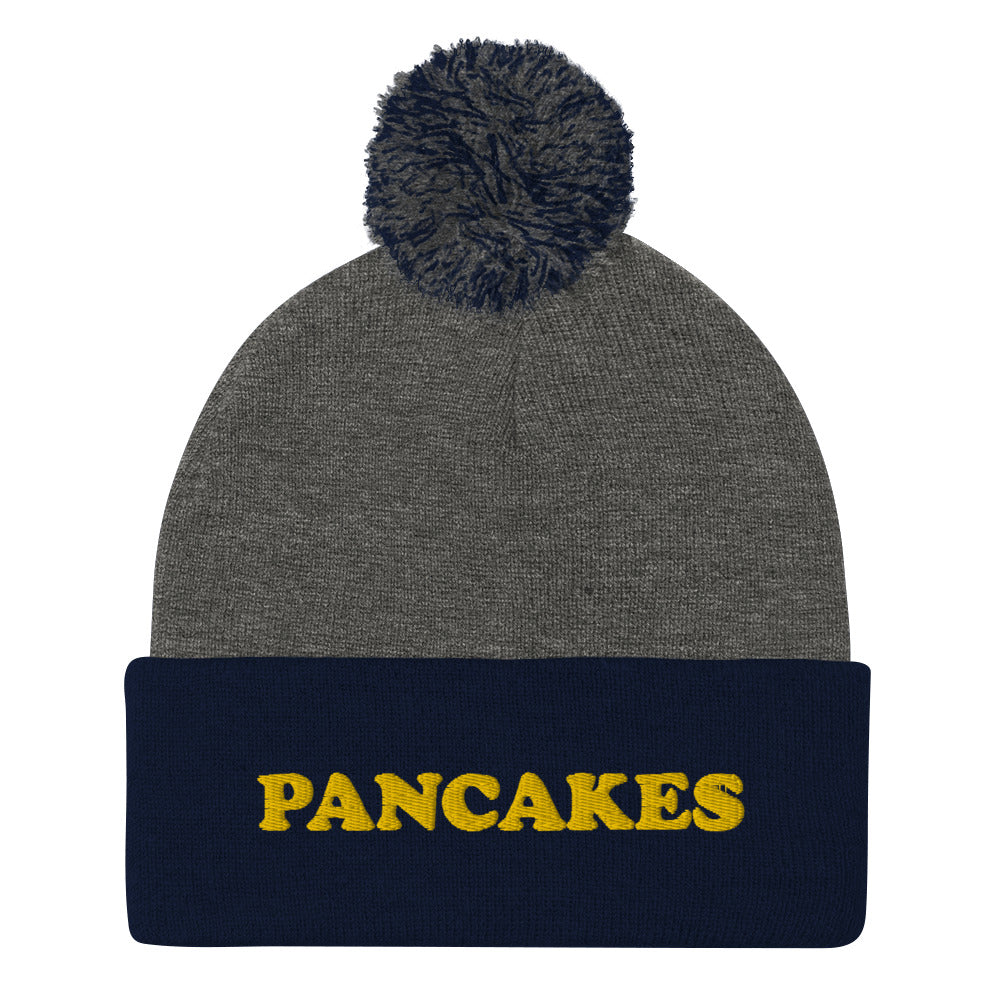 Everyone loves pancakes and now you can show your love in this funny foodie pancake beanie. This unique embroidered "PANCAKES" beanie is warm and cozy with a classic pom pom. It's a perfect gift for foodies and weird hat people. Shop vegan foodie beanies, garlic hoodies, and funky designs in our shop. 