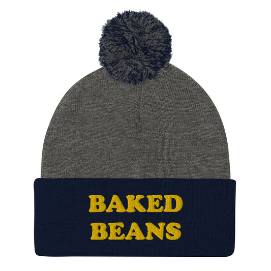 'BAKED BEANS' Pom-Pom Beanie. This funky foodie beanie is a warm and cozy hat for cold weather. It's a weird food beanie with a unique baked beans embroidery. This funny beanie is a perfect funny hat for a weird and funny gift idea. Ideal for foodies who love baked beans and funky fashion. Shop baked beans hats and more.