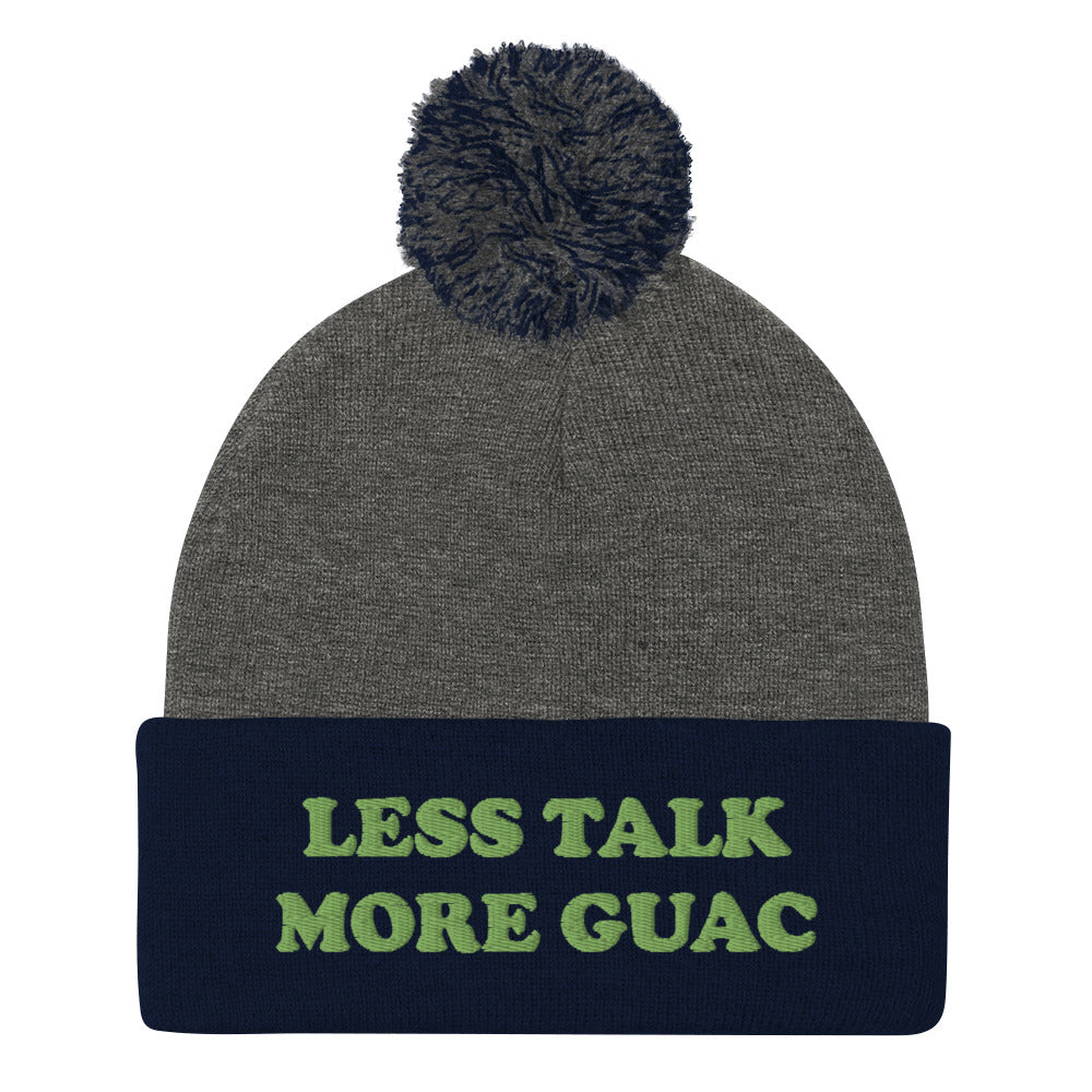 Navy blue and gray guacamole beanie with green embroidery. Less talk more guac! Make your priorities clear in this unique guacamole beanie hat. It's a classic pom pom beanie with a funky foodie yellow embroidery. This funny food quote hat is a perfect foodie beanie or unique gift for guacamole lovers. Now you can wear a funky guacamole quote hat and eat guacamole in style. 