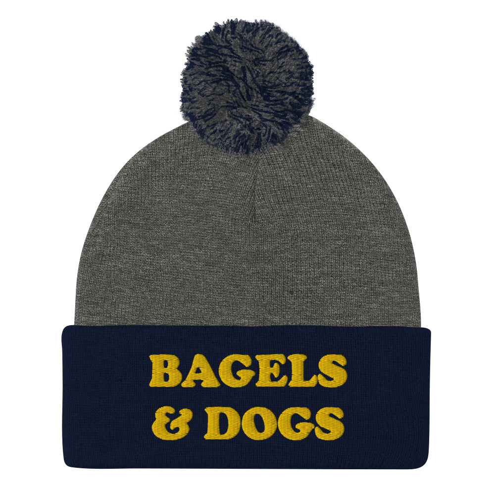 Bagel and dogs beanie in navy blue and gray - Keep your priorities in check with this bagels and dogs beanie with a pom pom on top. It's a unique and funny beanie for foodies and animal lover. Now you can eat bagels and pet dogs in a cozy hat that makes people smile. Stay weird and celebrate your favorite foods and animals in our funky clothing and accessories.