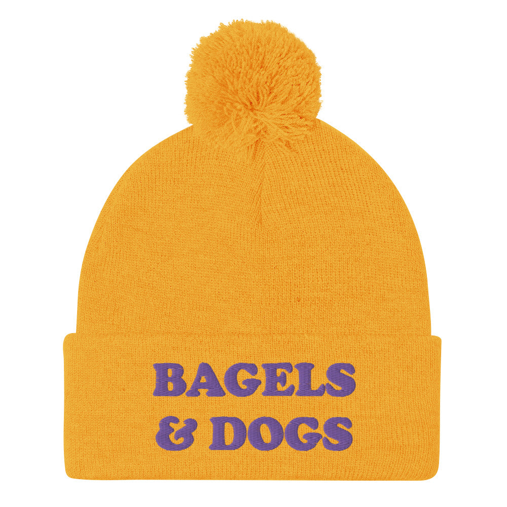 Yellow and purple bagels and dogs beanie - Keep your priorities in check with this bagels and dogs beanie with a pom pom on top. It's a unique and funny beanie for foodies and animal lover. Now you can eat bagels and pet dogs in a cozy hat that makes people smile. Stay weird and celebrate your favorite foods and animals in our funky clothing and accessories.