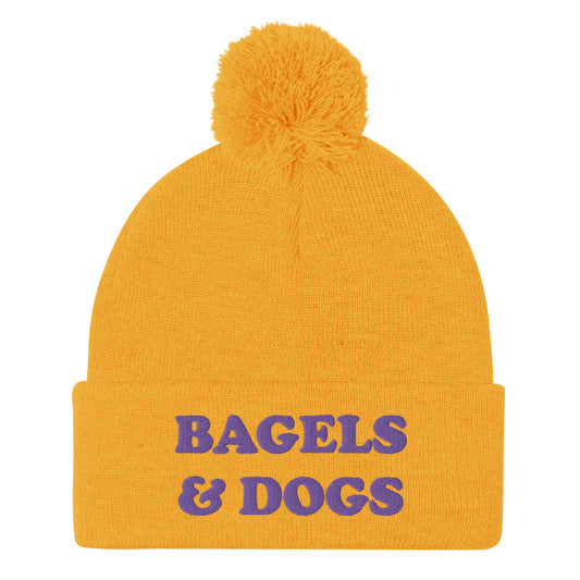 Yellow and purple bagels and dogs beanie - Keep your priorities in check with this bagels and dogs beanie with a pom pom on top. It's a unique and funny beanie for foodies and animal lover. Now you can eat bagels and pet dogs in a cozy hat that makes people smile. Stay weird and celebrate your favorite foods and animals in our funky clothing and accessories.