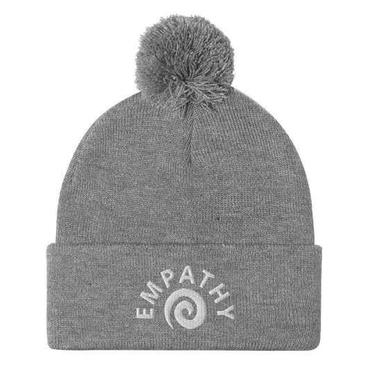 The empathy beanie is a classic embroidered beanie with a meaningful design and a pom-pom on top. The world needs for empathy and kindness. Wear this spiral design, inspirational word and make a fashionable statement. We create funky and unique statement clothing designs. Shop funky, unique, weird, and foodie fashion.