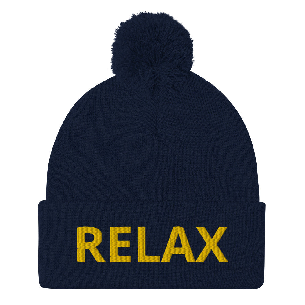 Navy Relax beanie hat from Nina's Funky Shop - Relax in this statement beanie. It's a warm and cozy beanie with "relax", expertly embroidered on the front. A funny hat with a classic pom pom on top and a yellow design. Designed by Nina and made just for you.