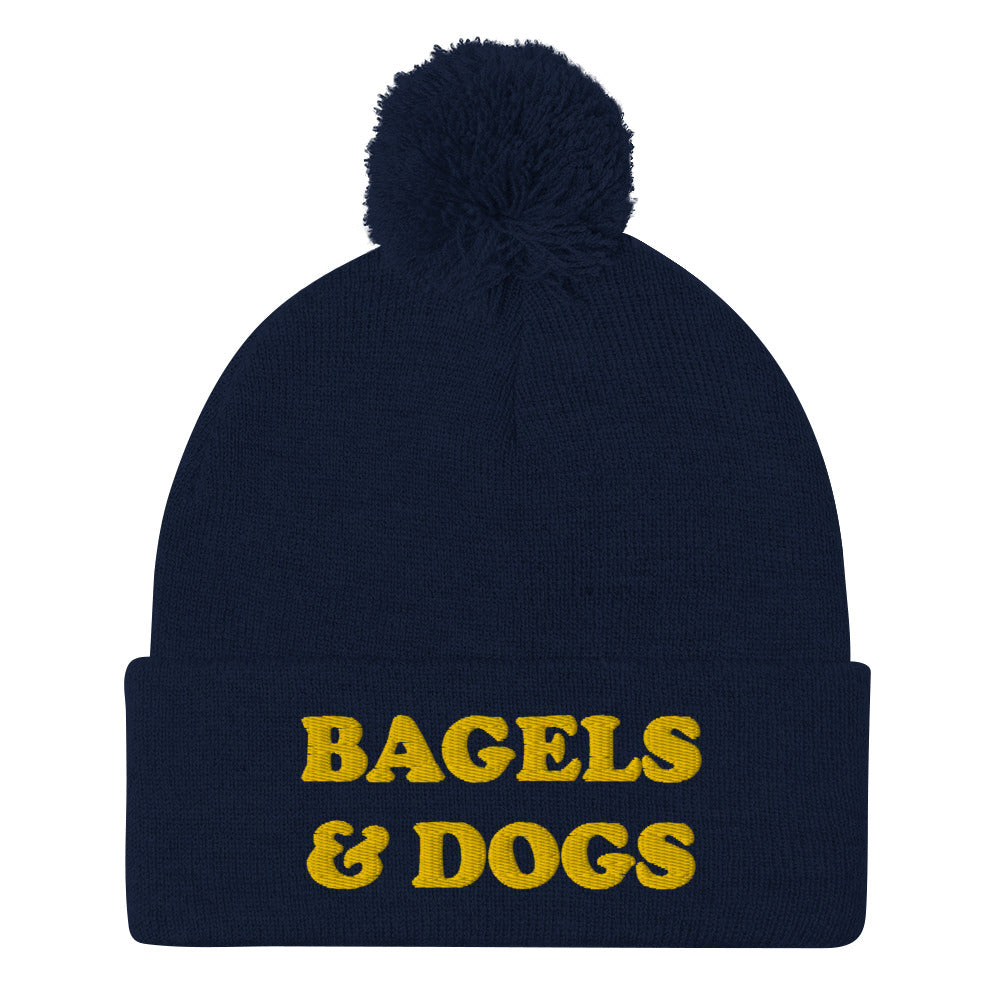 Navy blue bagels and dogs beanie - Keep your priorities in check with this bagels and dogs beanie with a pom pom on top. It's a unique and funny beanie for foodies and animal lover. Now you can eat bagels and pet dogs in a cozy hat that makes people smile. Stay weird and celebrate your favorite foods and animals in our funky clothing and accessories.