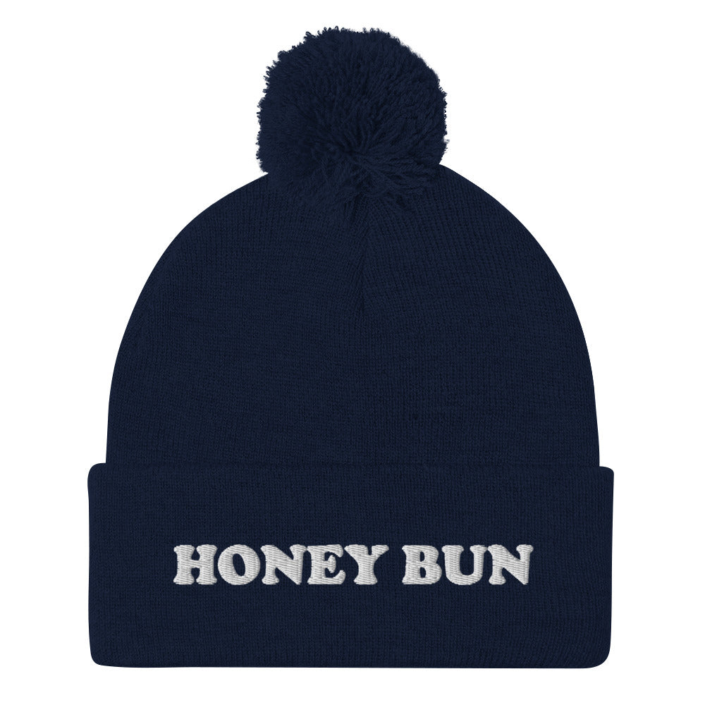 Navy blue honey bun beanie - Honey Bun Pom-Pom Beanie. This cute foodie beanie is a perfect warm and cozy hat for cold weather. It's a classic beanie with a pom pom on top and unique white embroidery. The funny honey bun hat is a weird foodie hat that's a perfect gift for foodies and honey bun lovers.  Stay warm in our funky foodie clothing.