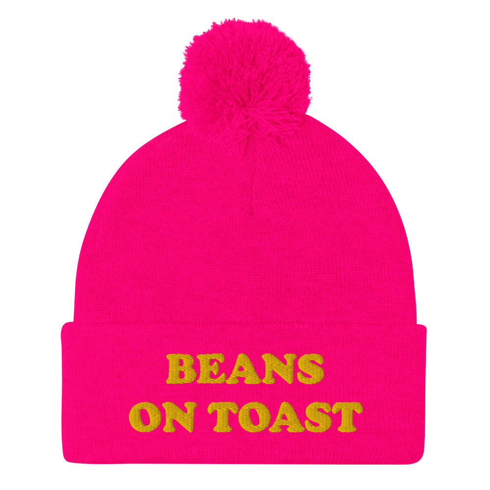 Hot pink beans on toast beanie with pompom - UK food beanie - This beans on toast beanie is a unique, warm & cozy hat. It's a classic beanie with a pompom and a funny food embroidery. Celebrate your favorite British foods in our funny food hats and weird food clothing. This beans on toast, British food beanie can be a funny gift for foodies or a weird hat for everyday streetwear.