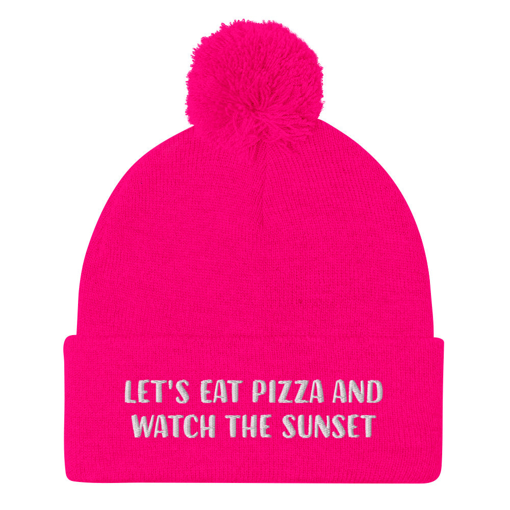 Hot pink funny foodie beanie. Chase the sunset and eat pizza beanie - Let's eat pizza and watch the sunset in a unique beanie with a funny message. This cute beanie is a warm hat for cozy nights in and outdoor adventures. It's a classic unisex embroidered beanie with a pom pom on top. Love sunsets and pizza? Wear this funny foodie beanie or give it as a unique gift for pizza lovers.   