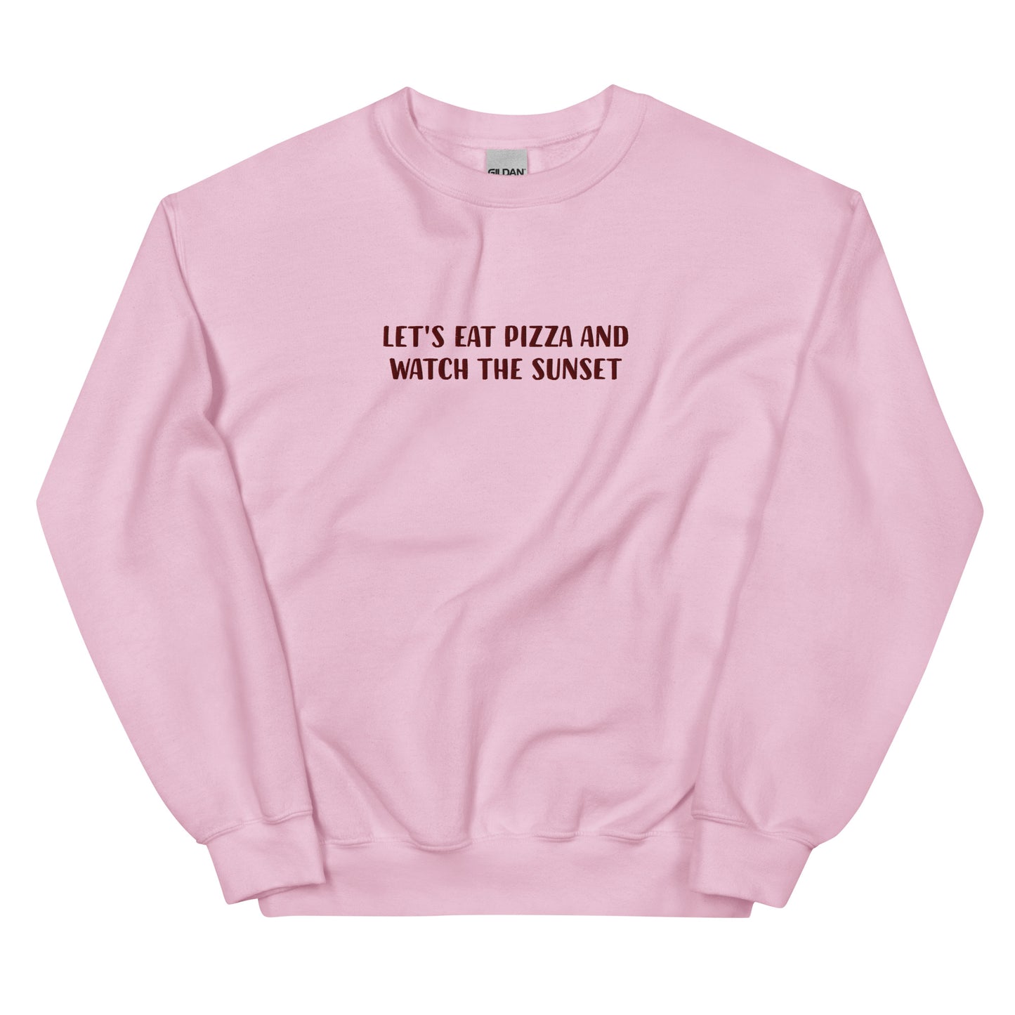 Light pink funny sweatshirt with cute message about pizza and sunsets - Let's eat pizza and watch the sunset. This funny foodie sweatshirt is original, comfortable and made just for you. A unique embroidered sweatshirt for pizza lovers. It's the perfect weird sweatshirt for foodies, sunset chasers and pizza enthusiasts. Stay weird and celebrate your favorite foods in our funky foodie clothing.